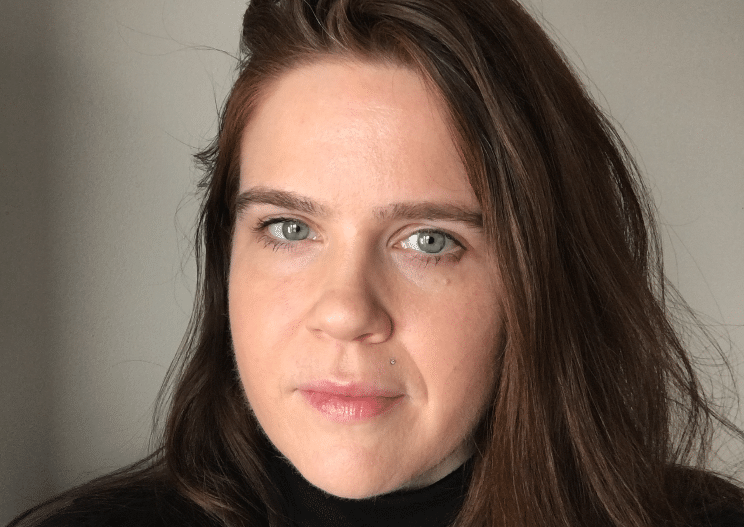 Headshot of Ashley Gryskiewicz, MSW, LICSW, in a black turtleneck sweater.