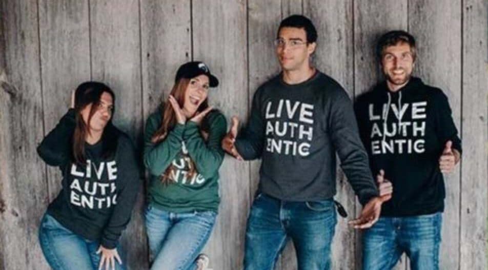 Four Ellie Mental Health professionals posing for the camera wearing branded Ellie Mental Health LIVE AUTHENTIC sweatshirts.