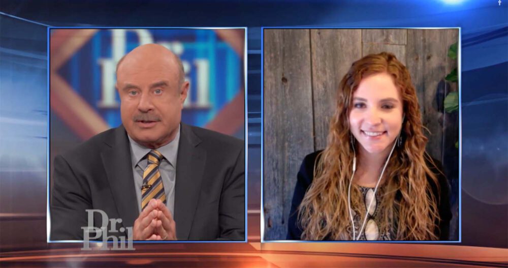 Dr. Phil speaking with Erin Pash, Chief Executive Officer and Founder of Ellie Mental Health, who's dressed in a dark top and has long reddish hair, on the Dr. Phil Show.