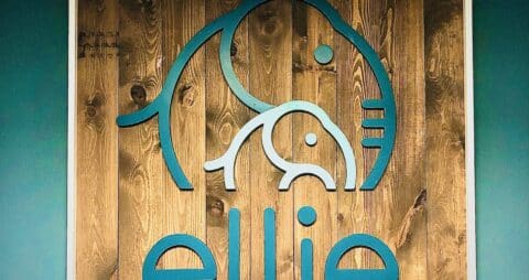 An Ellie Mental Health office sign hanging on the wall.