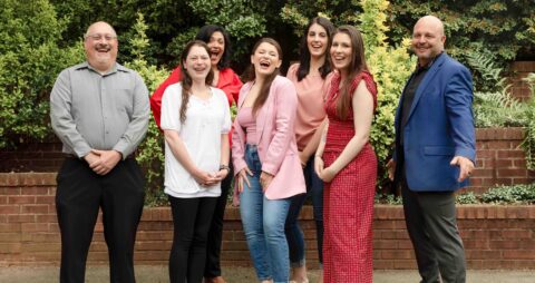 An exterior group photo of the Parsippany Team from their Ellie Mental Health therapy clinic in New Jersey.